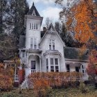 Victorian-style house with Halloween decorations in twilight.