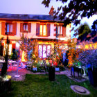 Colorful Whimsical House with Glowing Windows and Fantasy Garden at Dusk