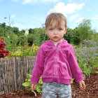 Child in Pink Hoodie on Whimsical Fantasy Path with Bird and Butterflies