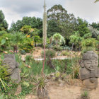 Fantastical landscape with greenery, waterfalls, tiered houses, and serene waters.