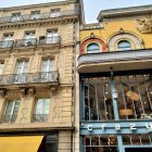 Colorful mosaic tiles and intricate ironwork on whimsical building facade