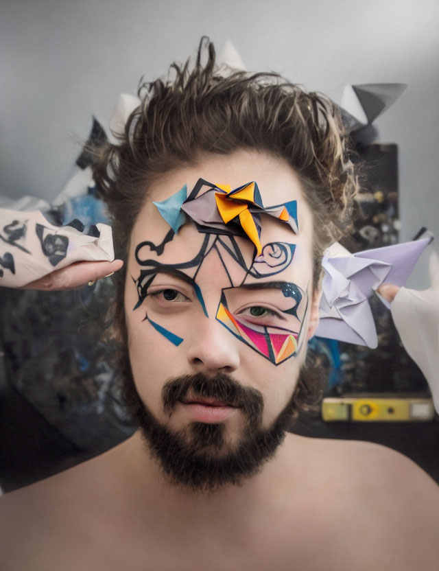 Cubist-inspired facial painting with origami birds and serious expression