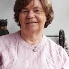 Elderly Woman with Warm Smile in Floral Cardigan