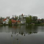 Moss-Covered Cottage on Island in Foggy Forest Pond