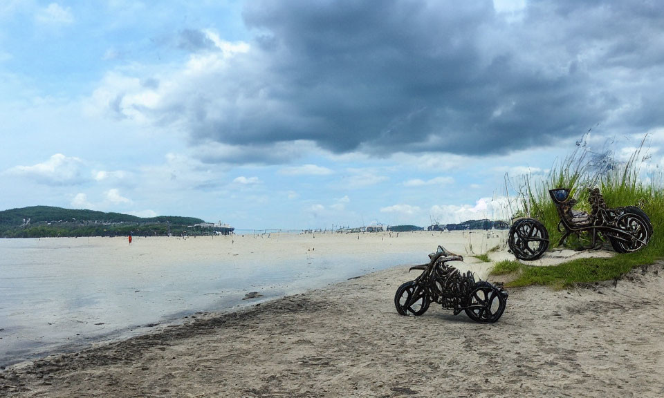 Tranquil beach scene with two motorcycles, calm waters, and cloudy sky