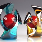 Vibrant metallic animal sculptures with apple and pear in surreal setting