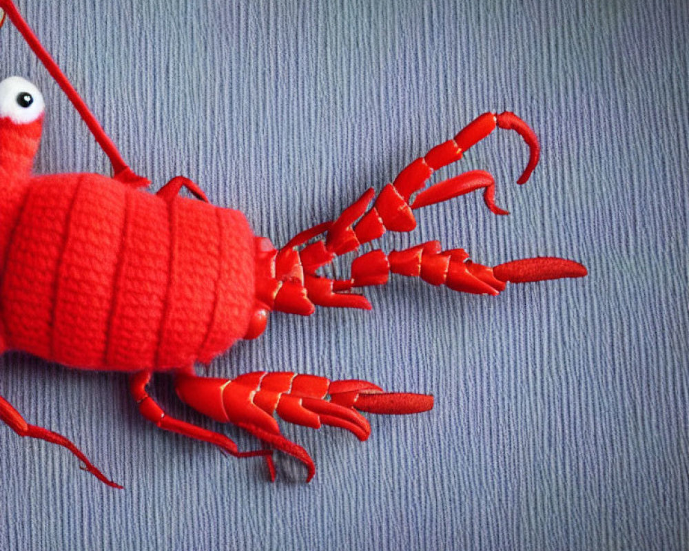 Red Lobster Plush Toy with White Eyes on Gray Surface