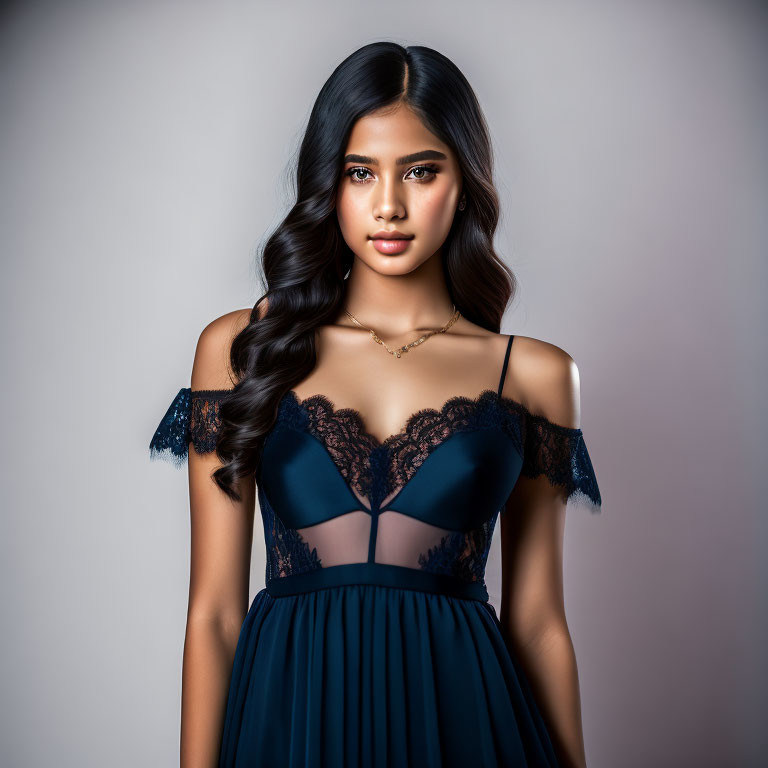 Woman with Long Wavy Hair in Dark Blue Lace Dress on Gray Background