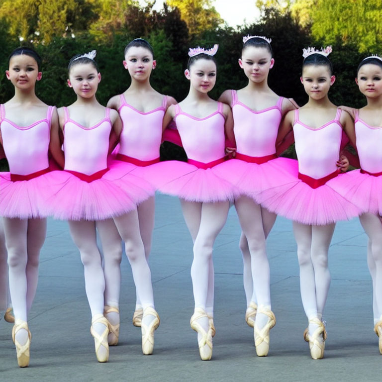 Young Ballerinas in Pink Tutus and Tiaras Posed En Pointe