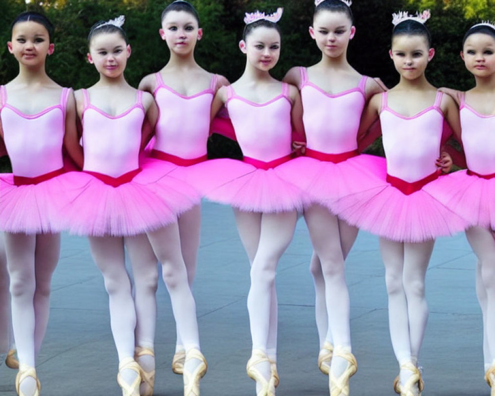 Young Ballerinas in Pink Tutus and Tiaras Posed En Pointe