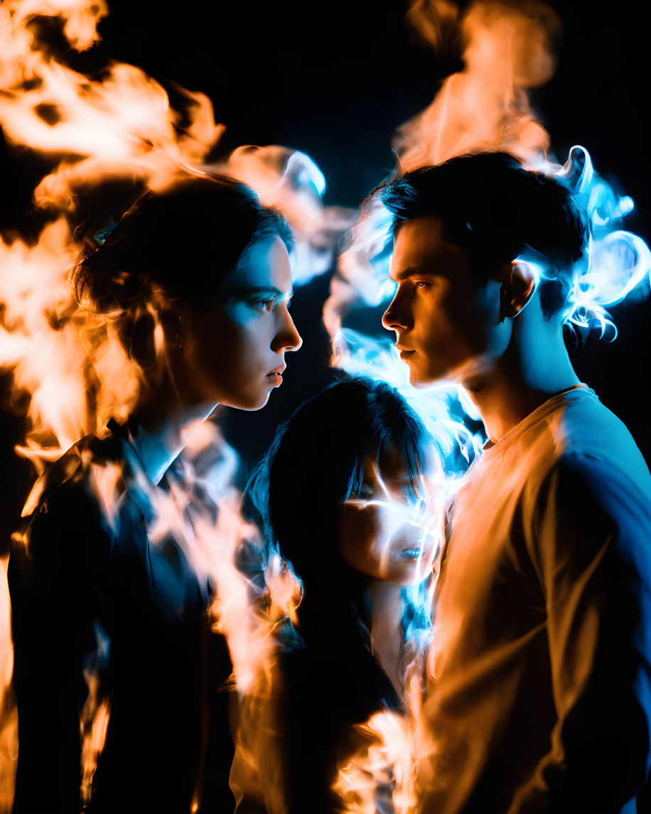 Intense profiles highlighted by orange and blue flames on dark backdrop