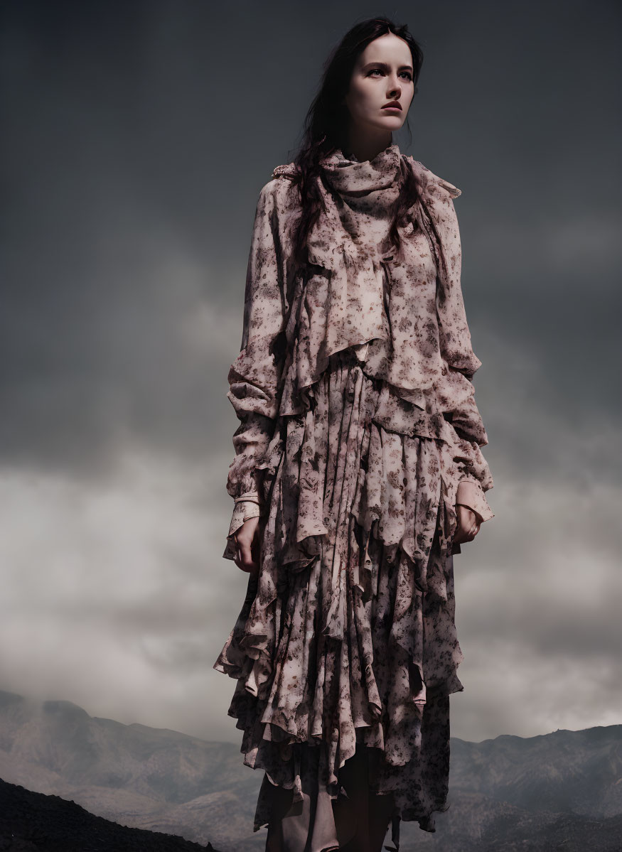 Somber woman in layered dress under dark sky