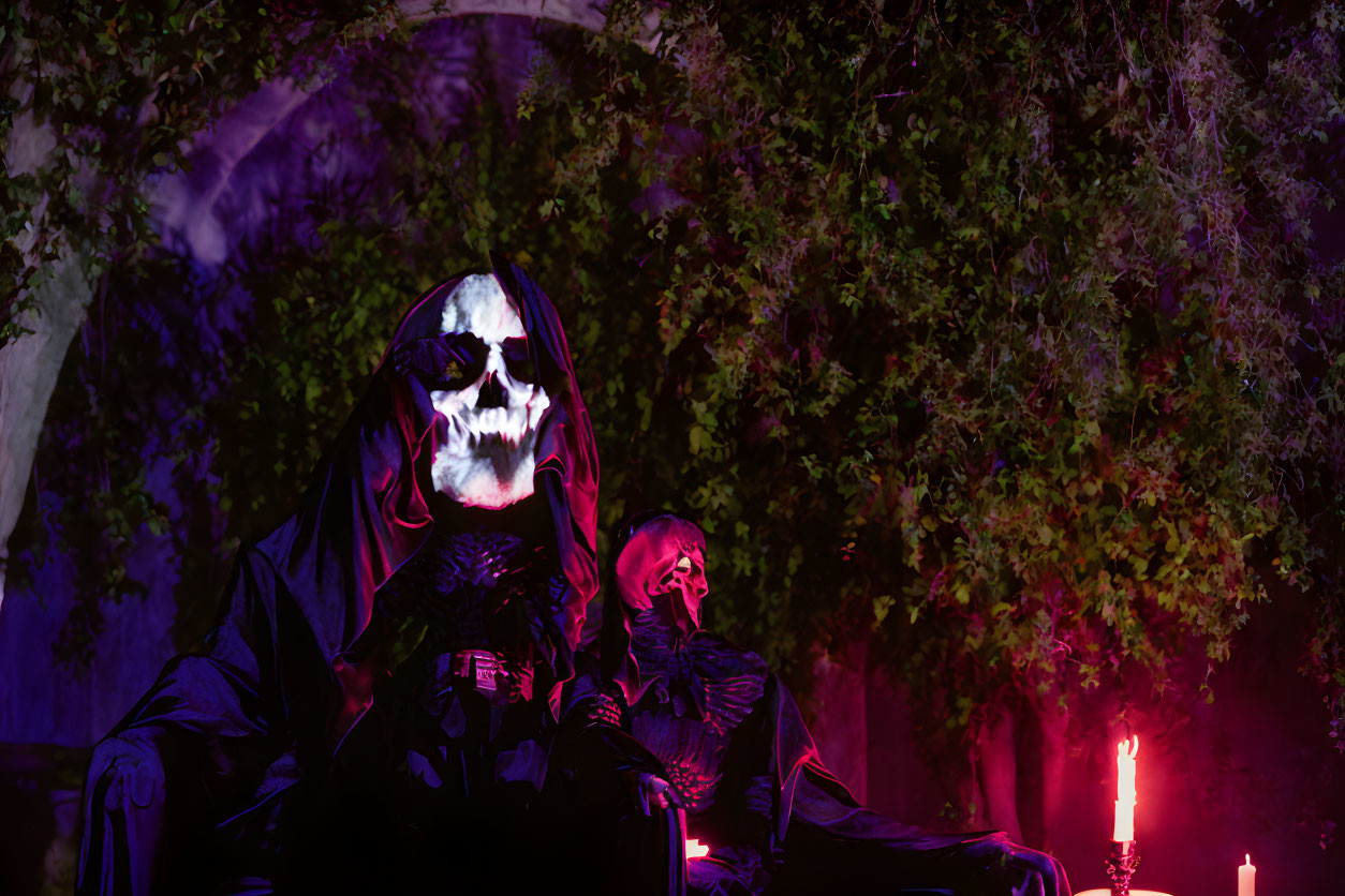 Two Skeleton Figures in Robes Surrounded by Greenery and Candles