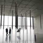 Four People Silhouettes in Room with Tall Windows & Pencil Sculptures