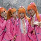 Young Women with Red Hair in Colorful Pink Outfits