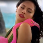 Woman Relaxing on Pink Flamingo Inflatable in Tropical Setting