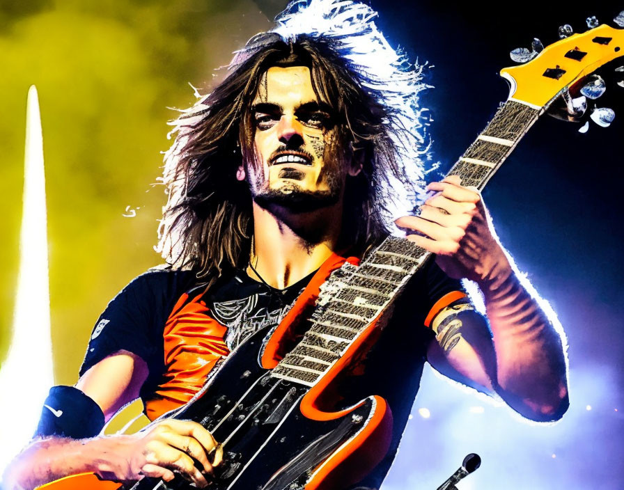 Long-haired guitarist performing energetically under vibrant yellow stage lights