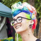 Surreal portrait of woman with blue ram horn hair and whimsical lighting