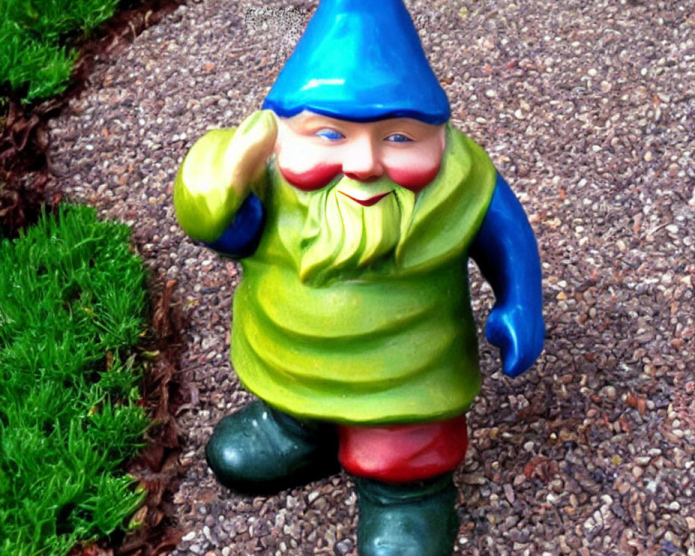 Colorful Garden Gnome Statue with Blue Hat and Red Pants on Gravel Near Grass Edge