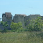 Tranquil landscape with stone monoliths, hills, trees, meadow, wildflowers,