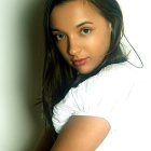 Colorful braided blue hair on girl with big brown eyes in white shirt