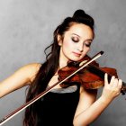 Woman with vibrant makeup playing violin in cosmic setting.