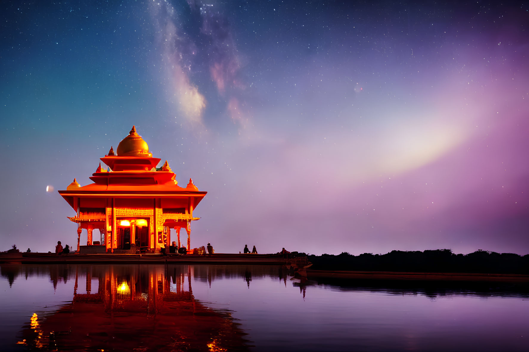 Traditional Temple Illuminated Against Milky Way Night Sky and Water Reflections