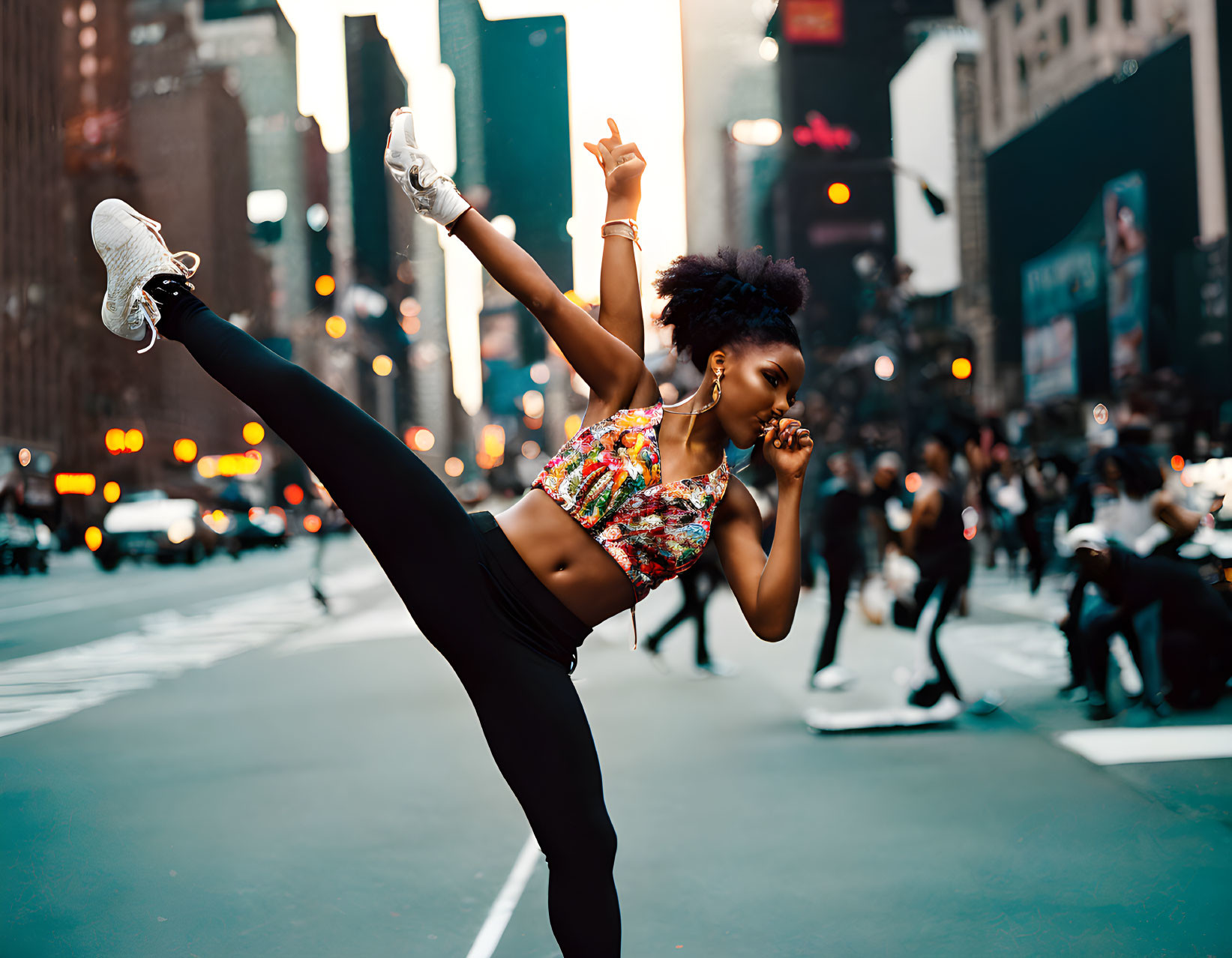 Dynamic dance move in city street with blurred lights & traffic