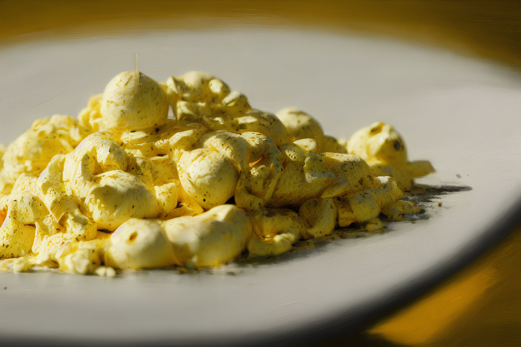 Plate of Scrambled Eggs with Herbs on White Plate