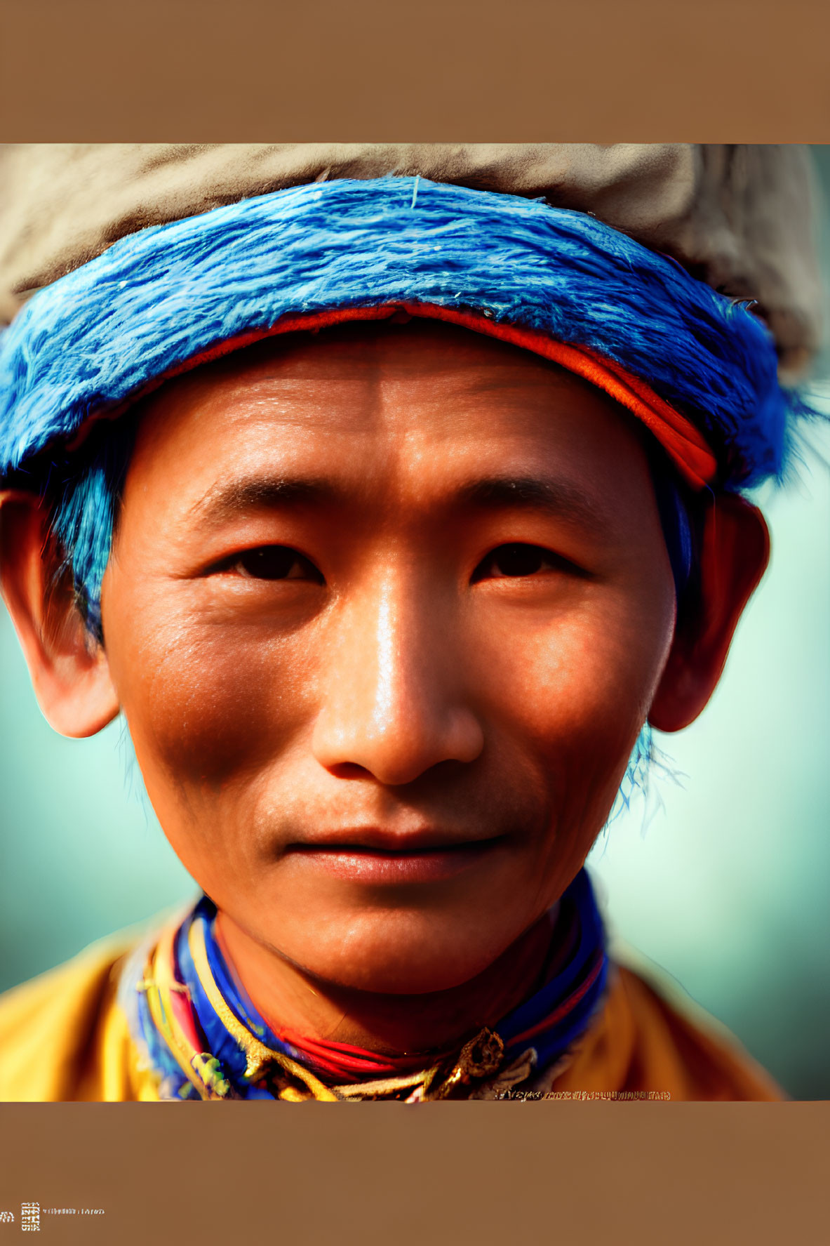 Traditional headwear and colorful outfit on a smiling man in close-up portrait