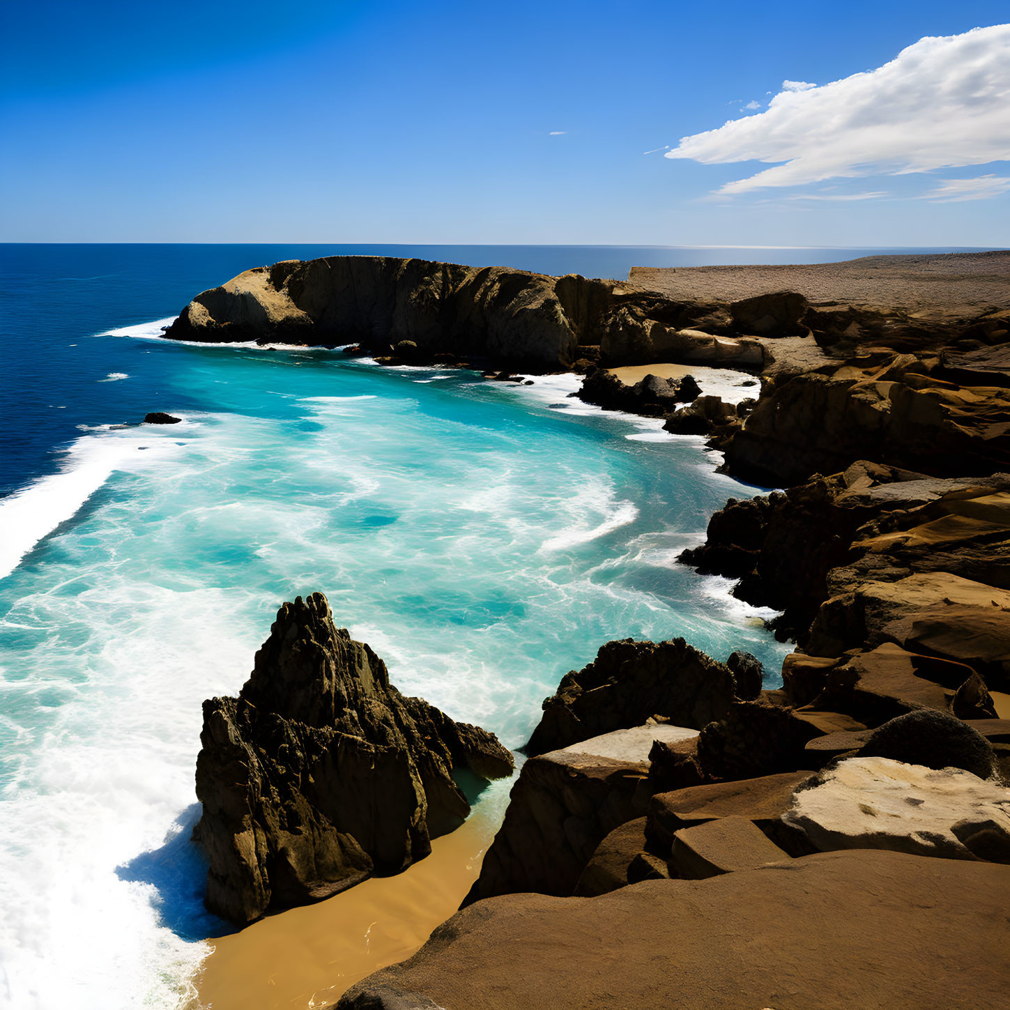 Scenic rocky coastline with crashing turquoise waves