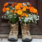 Brown Boots Overflowing with Vibrant Flowers Against Wooden Door