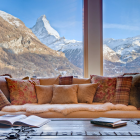 Winter Chalet Terrace with Plush Seating and Mountain View at Twilight