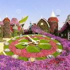 Vibrant flower garden with quaint houses and white pyramid landscape