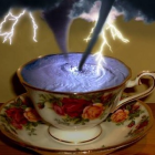 Golden cup and saucer with stormy sky and lightning on white cloud backdrop