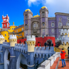 Multicolored fantasy castle with towers and turrets against blue sky