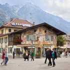 Snow-capped mountains and chalet-style buildings in an alpine village.