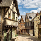 Picturesque cobblestone street with half-timbered houses and flowers