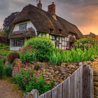 Thatched-Roof Cottage in Lush Garden with Stone Path