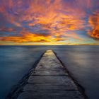 Fiery Sunset Reflecting on Ocean from Rocky Shore