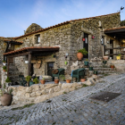 Enchanting village with stone houses and pink foliage under a starry sky