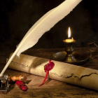 Vintage quill and scroll with candlelight, inkwells, and floral book - a romantic setting