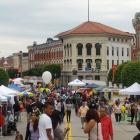 Colorful market scene with umbrellas, lanterns, and blue sky