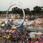 Vibrant amusement park with Ferris wheels and balloons