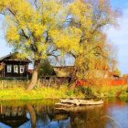 Autumn landscape: wooden church, golden trees, calm lake.