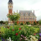 Whimsical pink house with red roof in lush garden and clock tower.