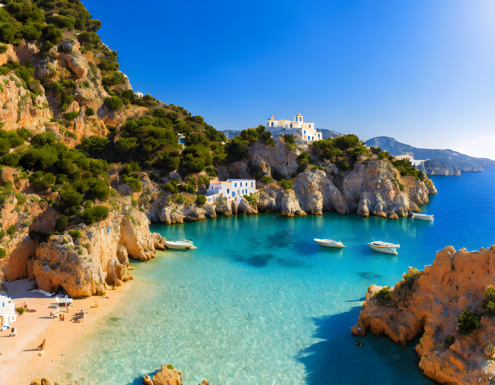 Scenic seaside with turquoise waters, sandy beach, white boats, and blue-roofed buildings