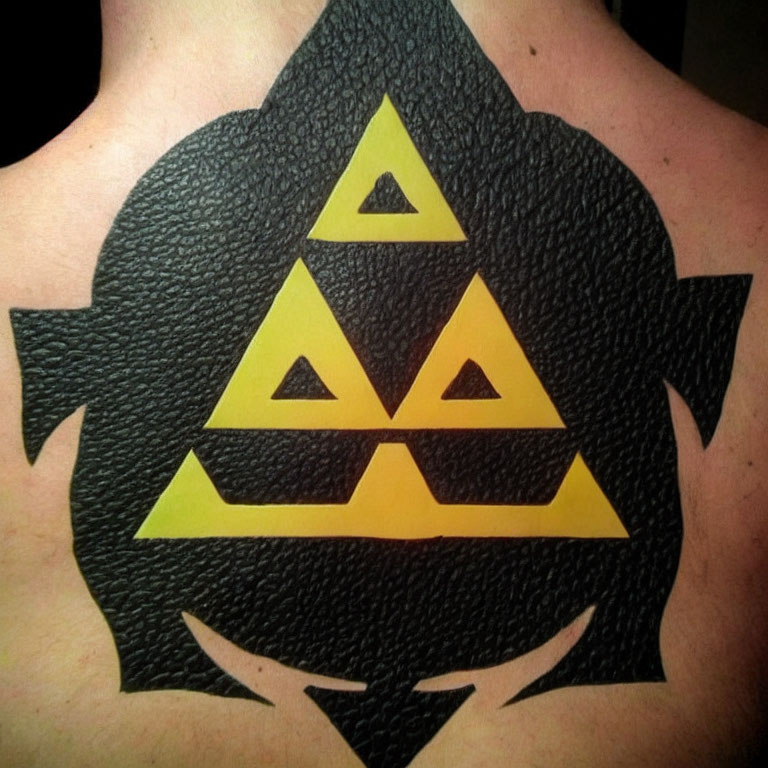 Triforce Symbol Tattoo on Upper Back with Black and Yellow Colors