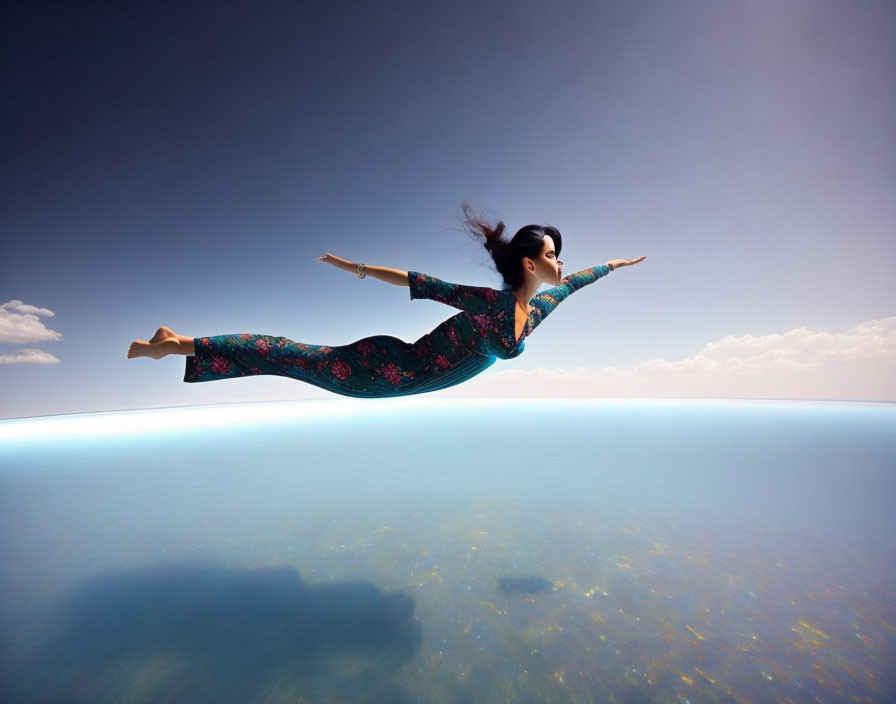 Woman Floating Above Calm Water Under Blue Sky