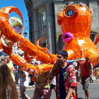 Colorful sunny parade with giant orange octopus float